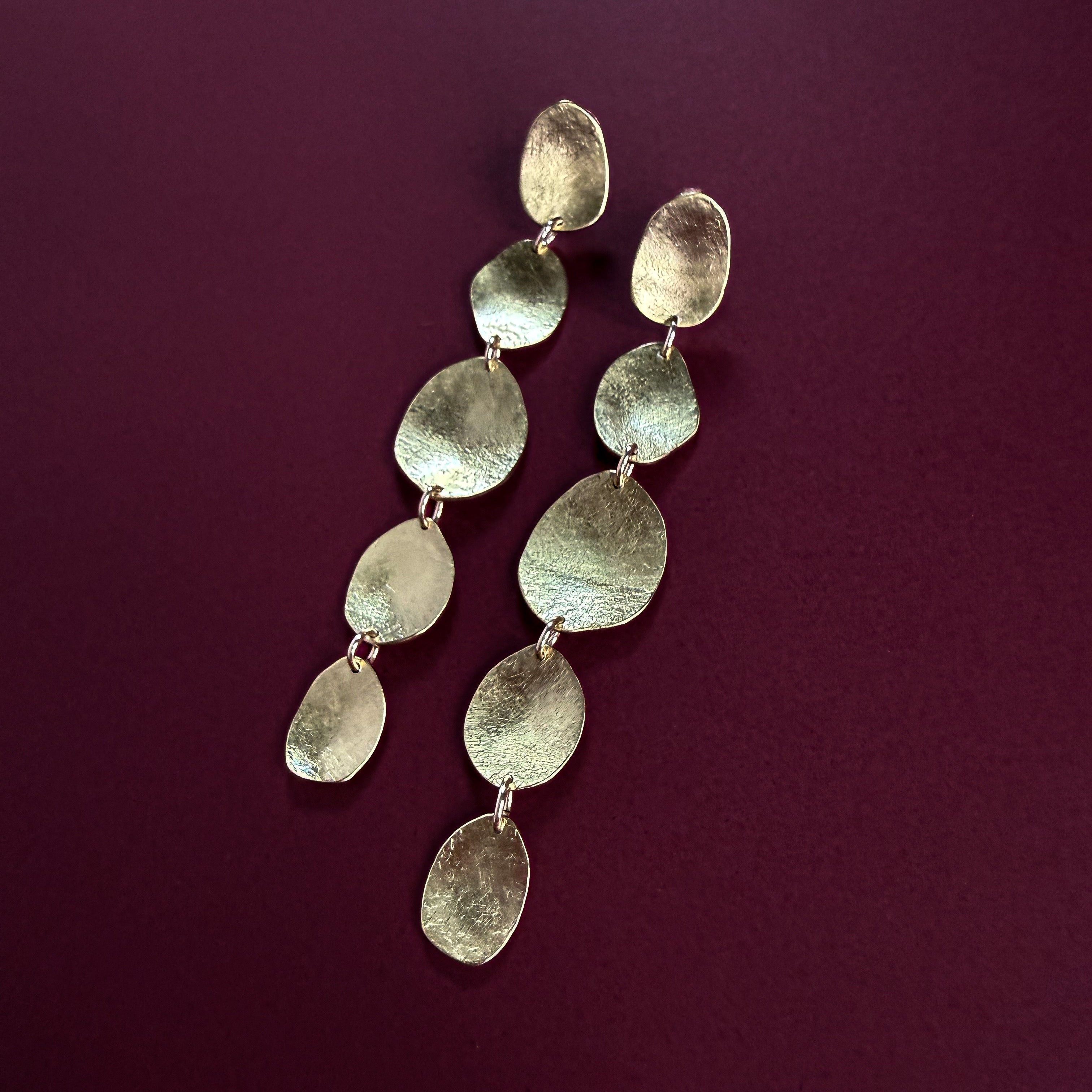 Aurelia brass pebble earrings showing hand-textured and gently formed surfaces