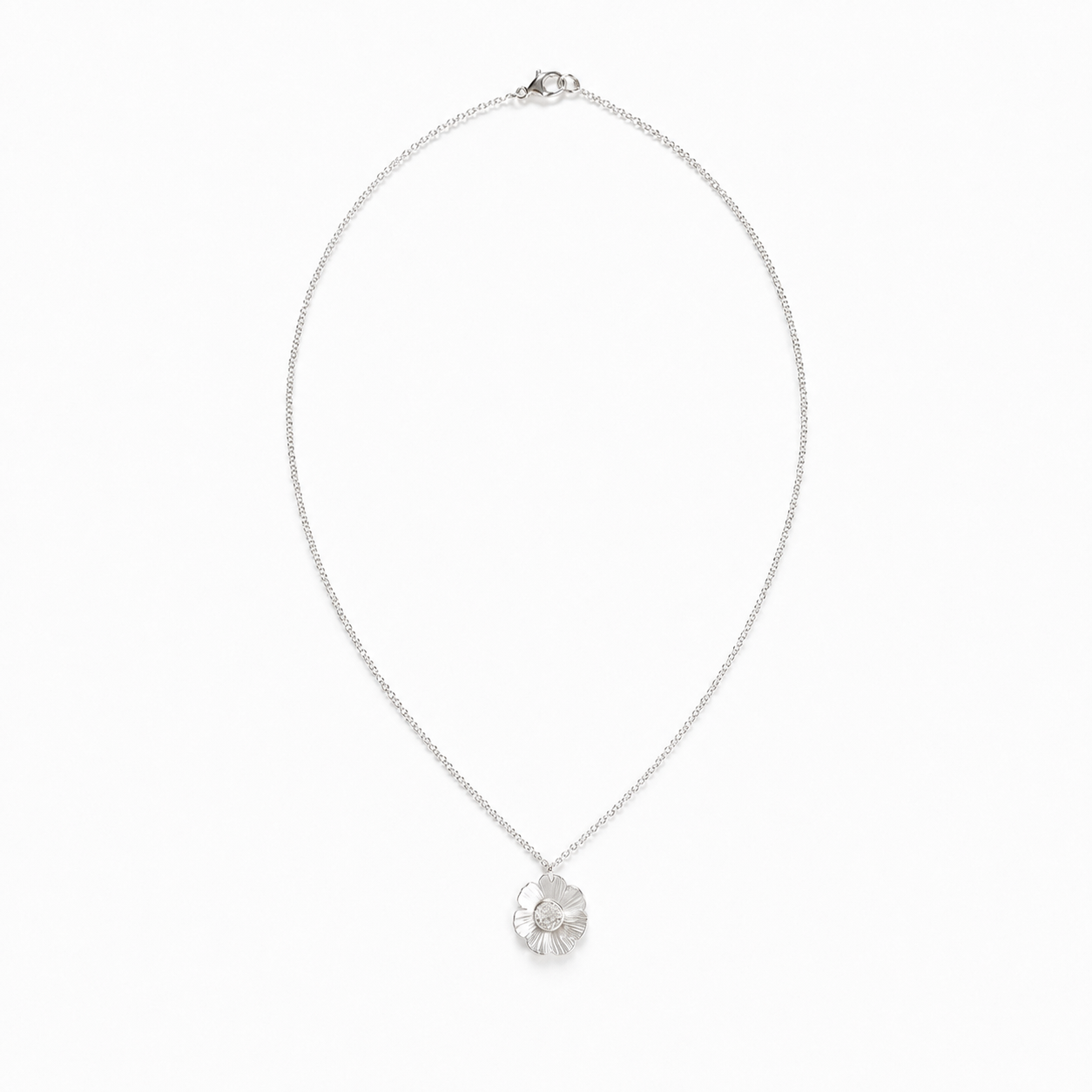 Handcrafted sterling silver flower necklace featuring a delicately textured floral pendant on a fine sterling silver chain. Handmade in Texas by Oh Little Foxes.