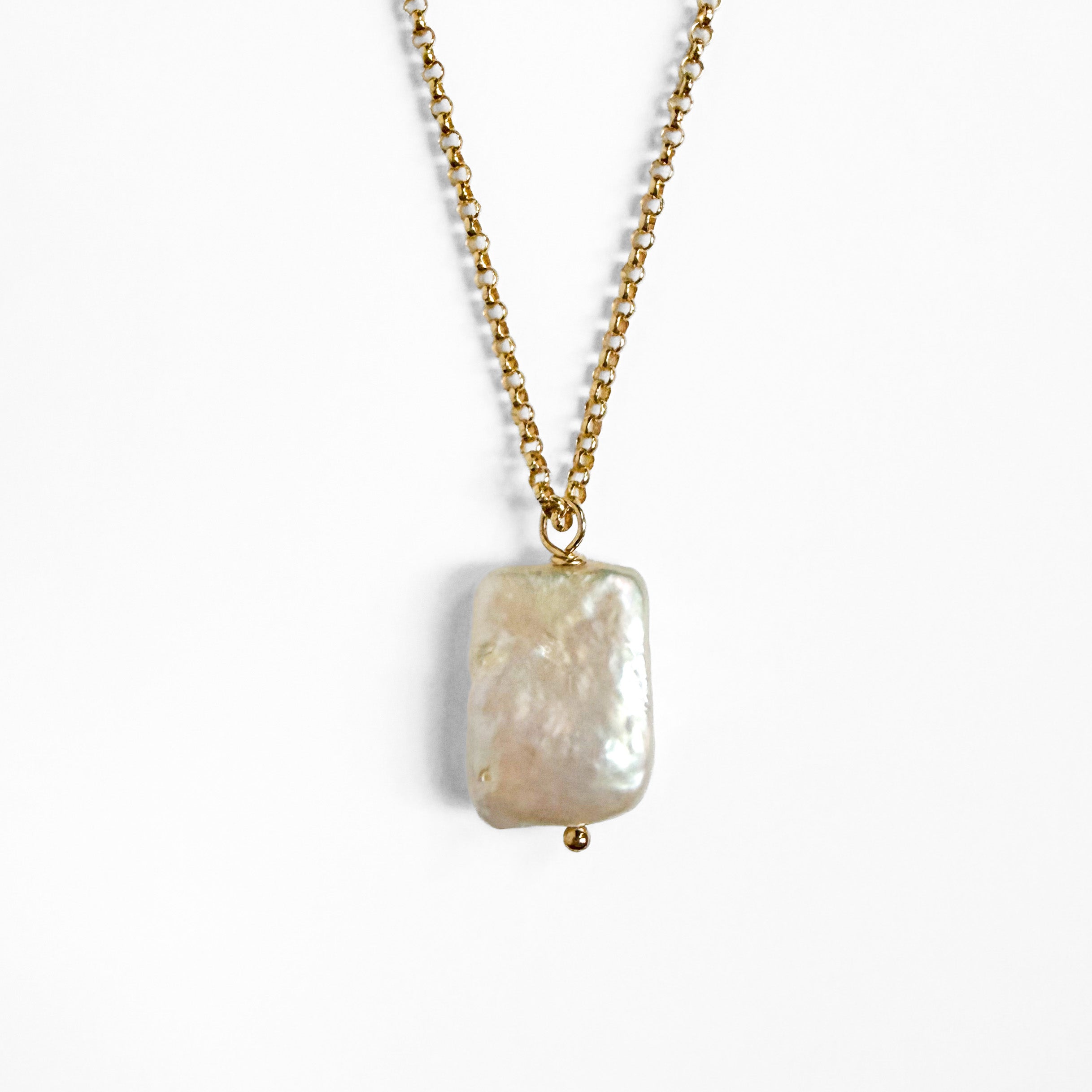 A gold chain necklace featuring a large, irregular baroque biwa pearl pendant, shown against a plain white background.
