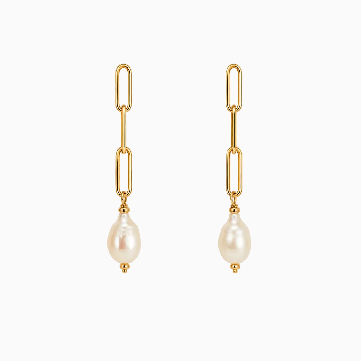 Handcrafted Maren pearl drop earrings featuring freshwater pearls suspended from elongated 14k gold-filled chain on a warm ivory background.