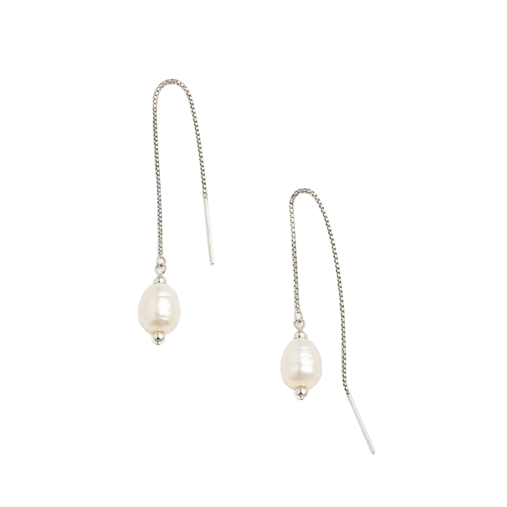 A pair of silver drop earrings featuring a small silver bead and a curved bareloi pearl dangle, displayed on a clean, solid off-white background.