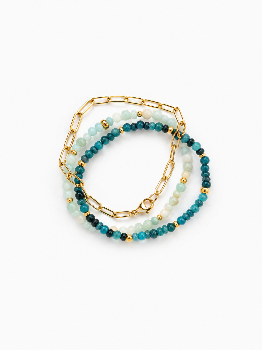 A stack of three beaded and chain bracelets on a clean white background. The stack includes a gold paperclip chain bracelet, a beaded bracelet with light blue-green and dark teal beads, and a matching beaded bracelet with dark teal and black beads.