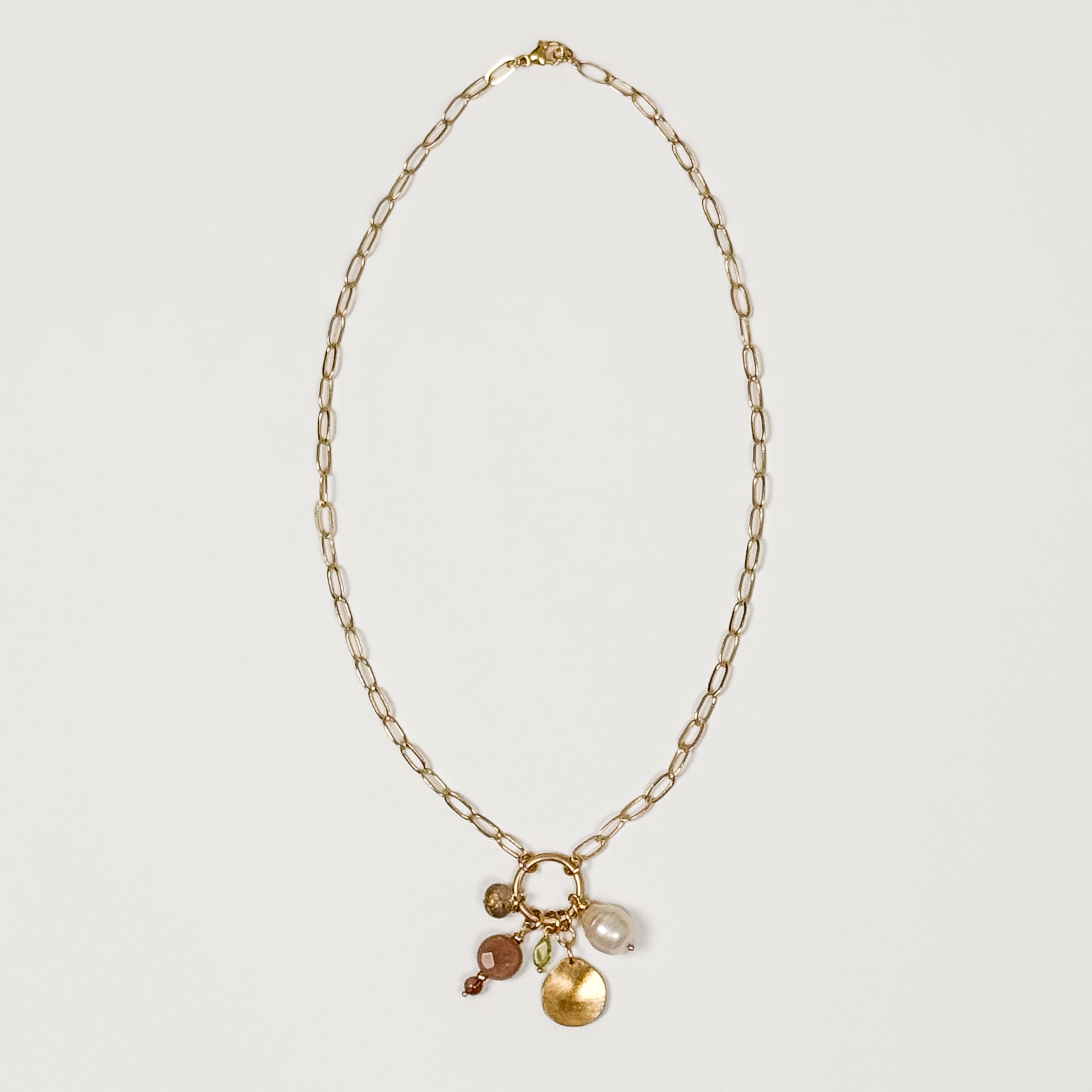 August gemstone charm necklace on 14k gold-filled chain with pearl and hand-fabricated brass pebble