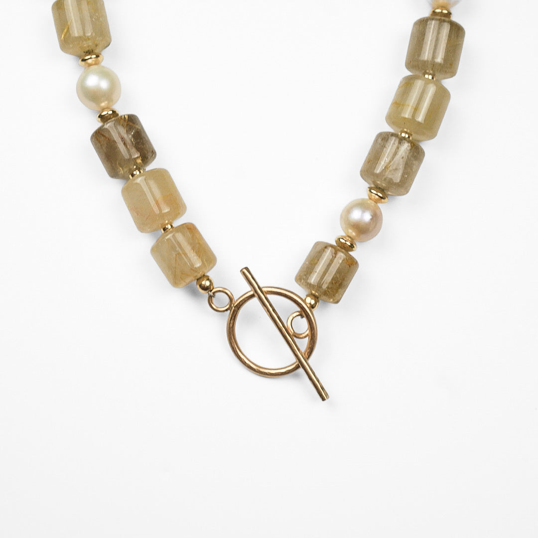 Aurelia Necklace featuring golden rutilated quartz rectangular nuggets, champagne freshwater pearls, and a 14k gold filled toggle clasp.