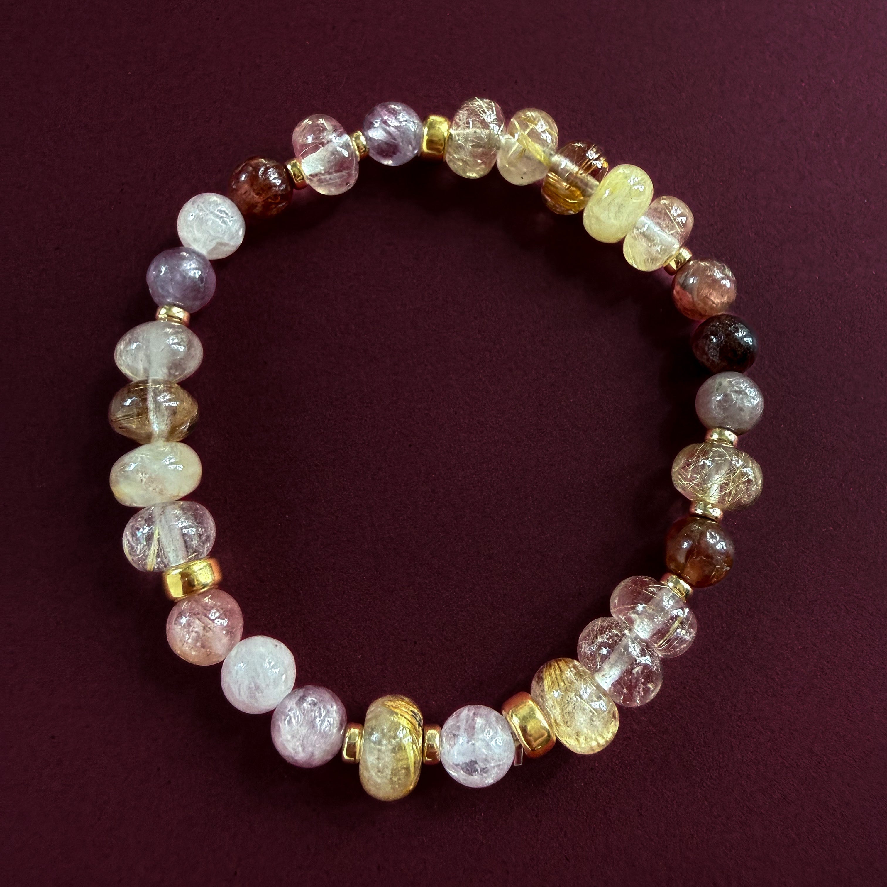 Close-up of Aveline bracelet showing natural golden rutilated quartz, pink spinel and gold-filled details