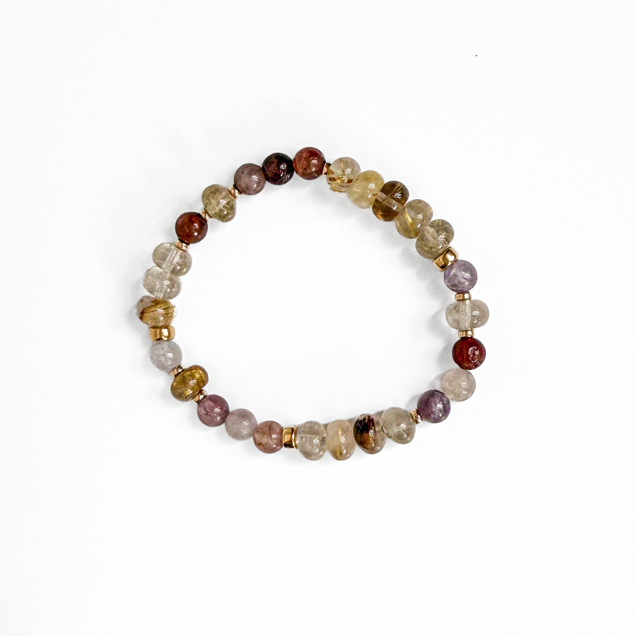 A beaded stretch bracelet made of translucent and opaque gemstone-like beads in assorted colors including brown, purple, yellow, and clear, separated by small metallic gold spacers, shown on a plain white background.
