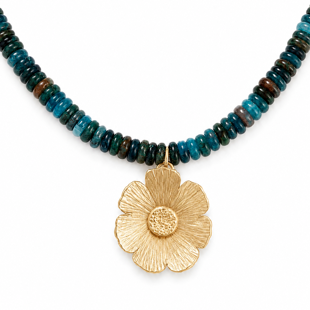 Blue apatite gemstone necklace with a handcrafted gold floral pendant.