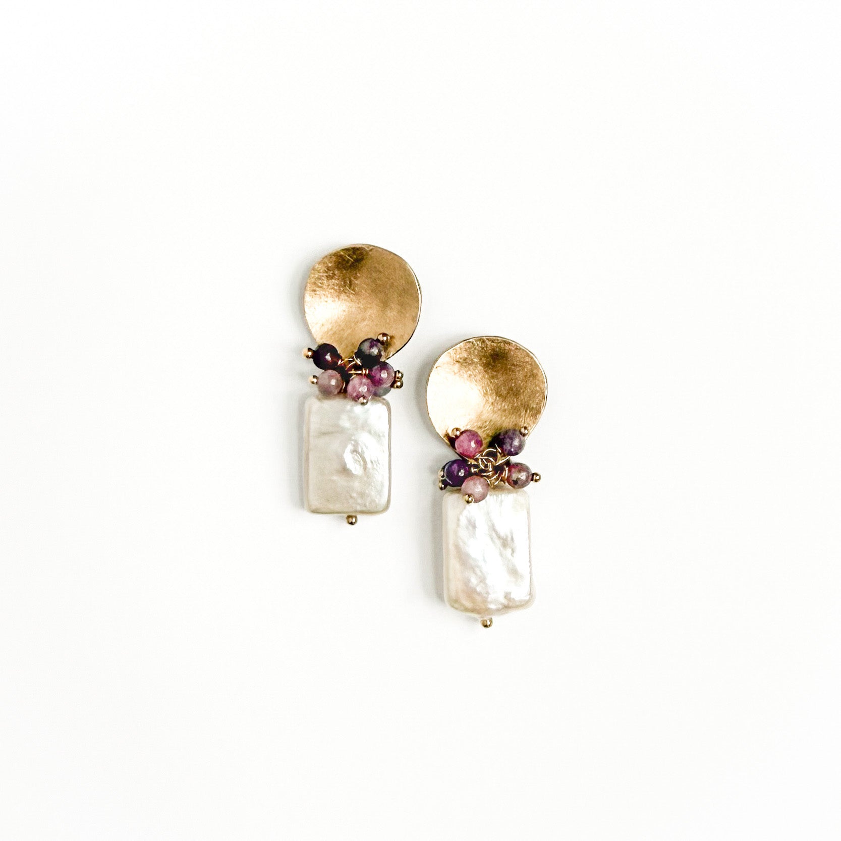 Figue Biwa pearl earrings featuring a brass textured pebble and delicate natural ruby gemstones over a freshwater rectangular pearl.