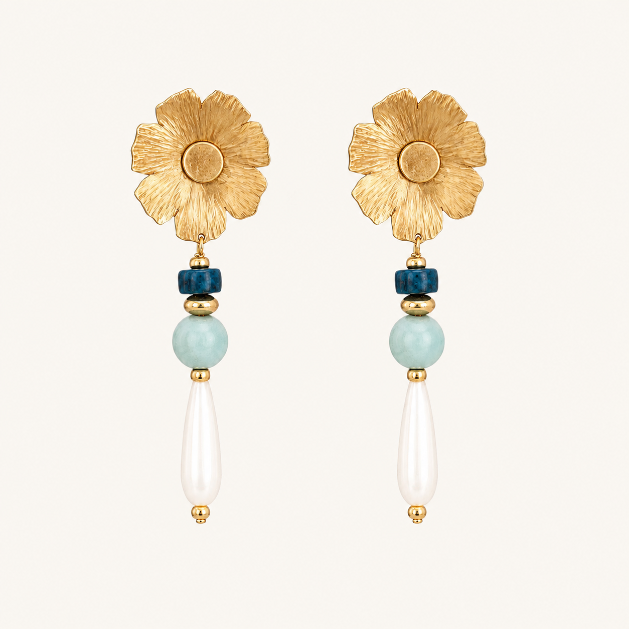 Handcrafted gold floral drop earrings featuring textured flower studs with blue apatite, amazonite, and elongated mother-of-pearl drops.