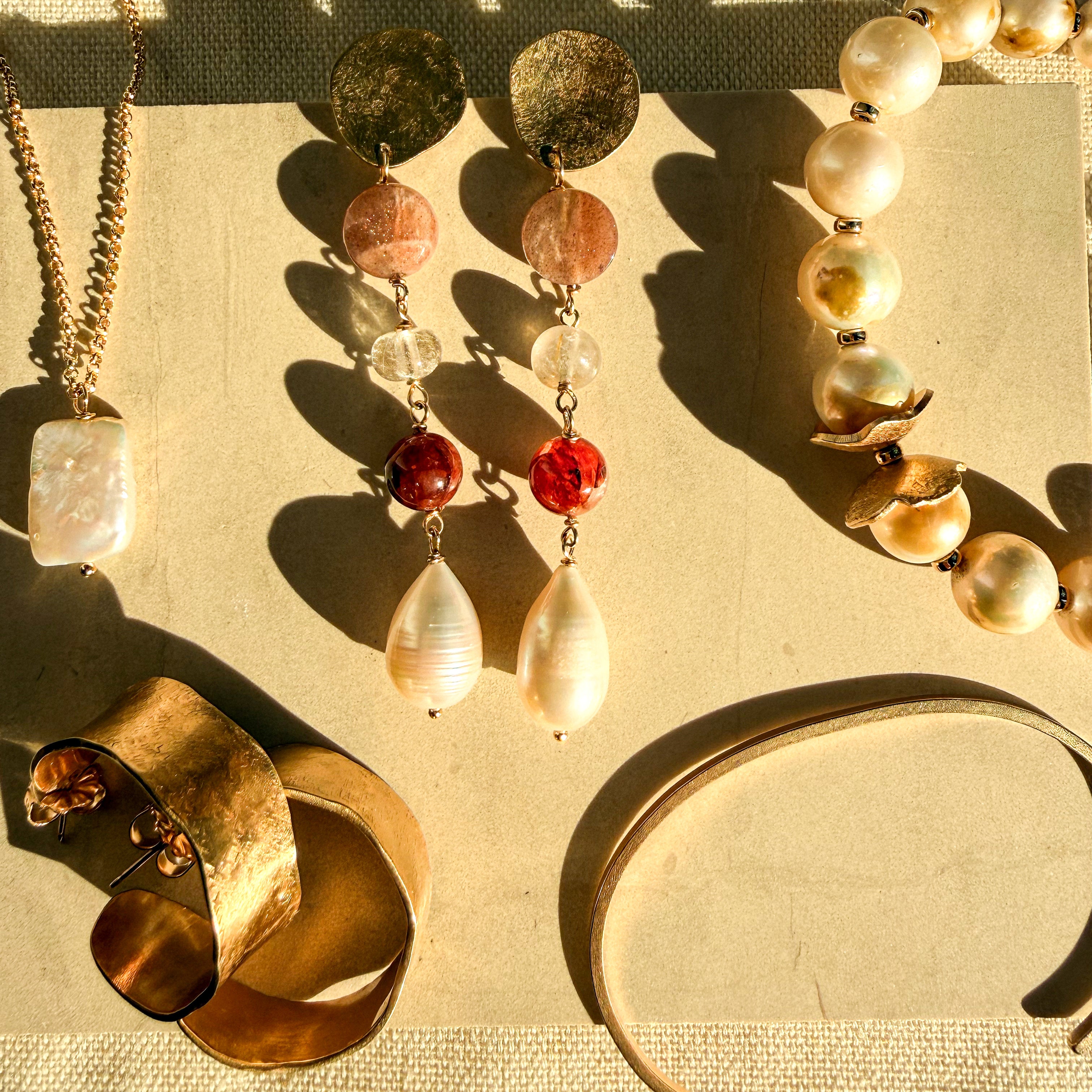 Solana hammered brass hoop earrings styled with handmade jewelry from the August Collection