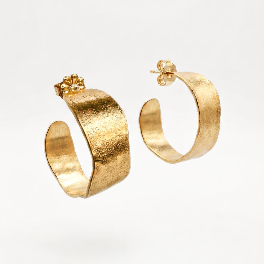Solana hand-hammered brass hoop earrings with organic curved edges and textured golden surface